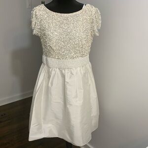 White baby doll dress with sequins at the top and beading along the waistband